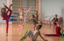 Young ballerinas dancing doing practice with ribbon in ballet studio.