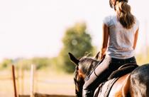 Picture of young pretty girl riding her horse