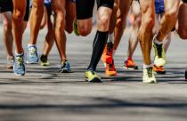 group legs runners athletes run on asphalt road marathon