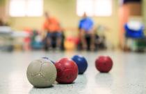 Disabled Boccia players training on a wheelchair. Close up of little balls
