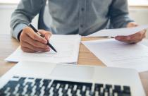 Businessman checking documents at table