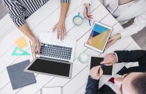 crop-coworkers-using-modern-devices-at-desk