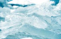 Closeup shot of a transparent shining clear ice sparkling on a frozen wild lakeshore