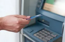 hand-inserting-atm-card-into-bank-machine-to-withdraw-money-businessman-men-hand-puts-credit-card-into-atm_1391-326