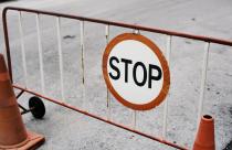 Mobile steel barrier fence with stop sign