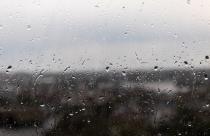 Closeup shot of a window on a rainy gloomy day, raindrops rolling down the window