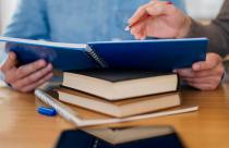 high-angle-of-man-holding-notebook