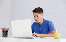 serious-guy-studying-with-laptop-desk