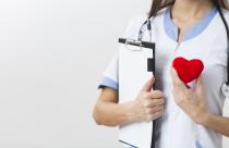 female-hands-holding-a-clipboard-and-a-plush-heart