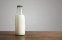 Antic blank bottle with milk on table