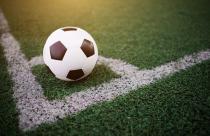 soccer ball on the white line at stadium