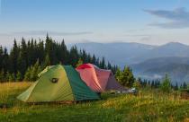 tourist-tents-are-in-the-green-misty-forest-at-the-mountains