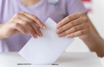 person-placing-its-vote-in-a-box