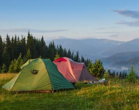 tourist-tents-are-in-the-green-misty-forest-at-the-mountains