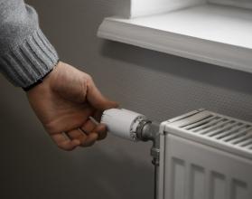 man-turning-off-radiator-during-energy-crisis