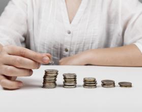 descending-piles-of-coins-and-woman