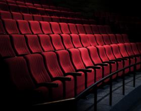 Rows of red seats in a theater