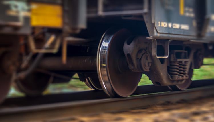 A close up view of a trains wheel in motion as it speeds past