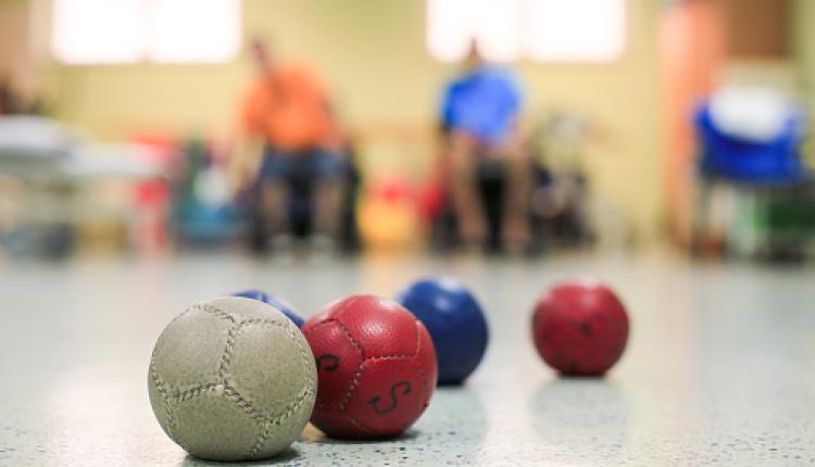 Disabled Boccia players training on a wheelchair. Close up of little balls