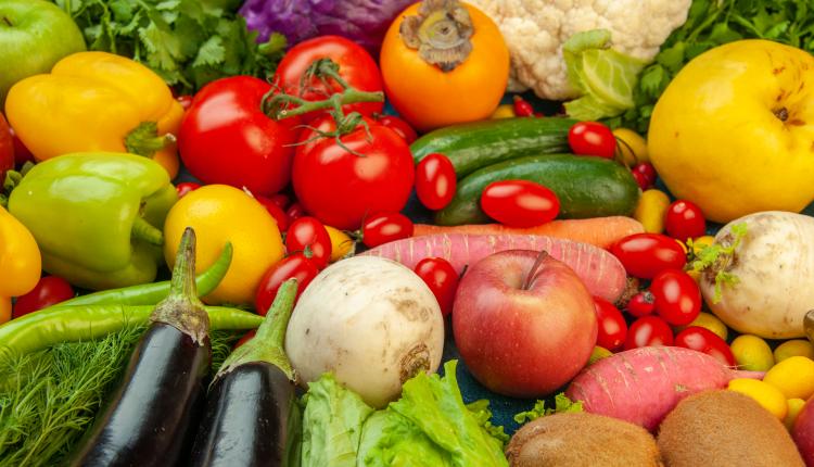 bottom-view-fruits-and-vegetables-radish-cherry-tomatoes-persimmon-tomatoes-kiwi-cucumber-apples-red-cabbage-parsley-quince-aubergines-on-blue-table