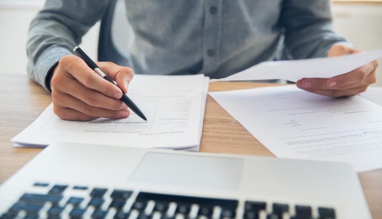 Businessman checking documents at table