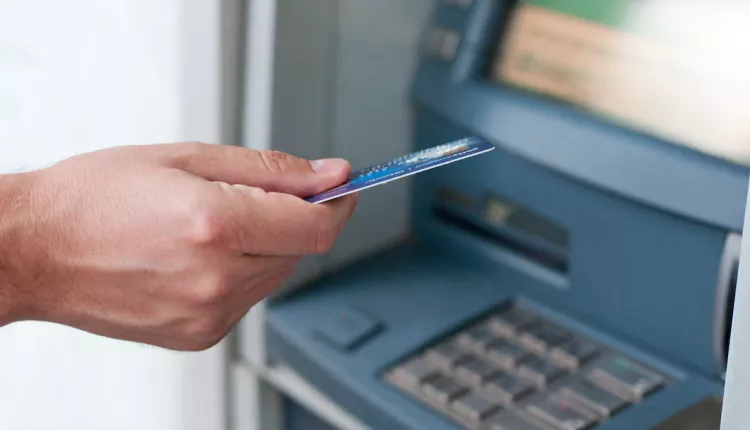 hand-inserting-atm-card-into-bank-machine-to-withdraw-money-businessman-men-hand-puts-credit-card-into-atm_1391-326
