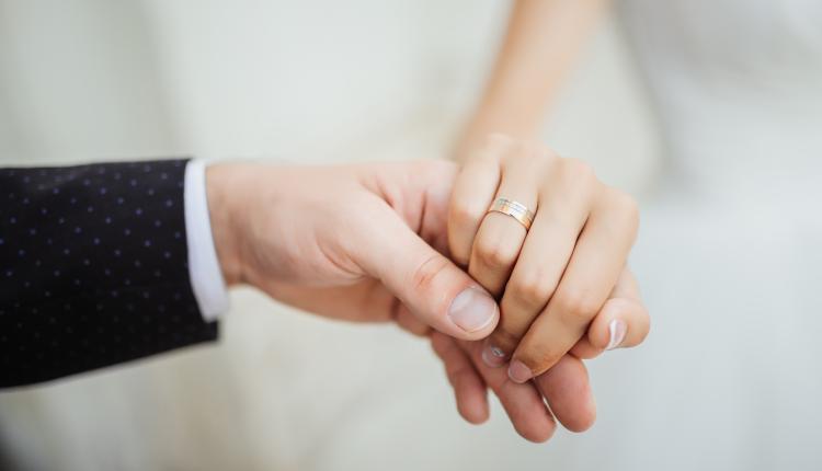 Wedding moments. Newly wed couple's hands with wedding rings