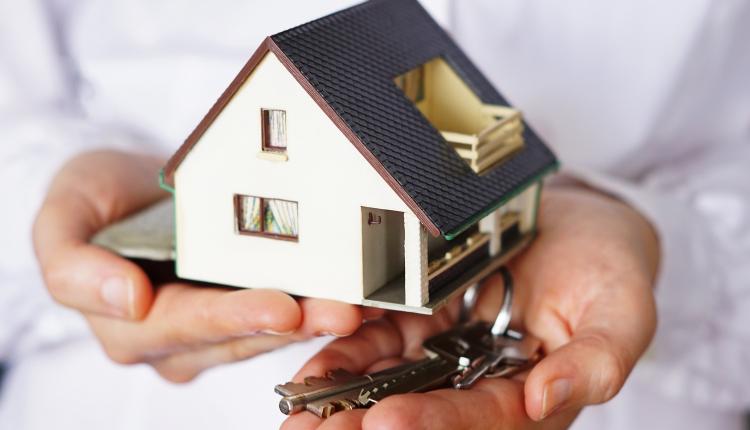 Closeup shot of a person thinking of buying or selling a house