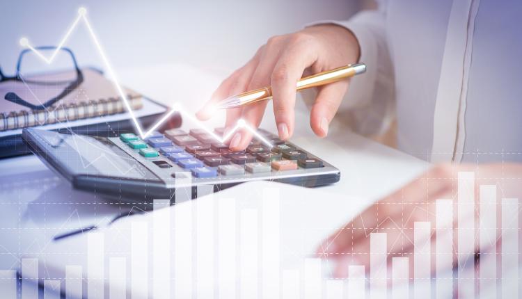 Accountant calculating profit with financial analysis graphs