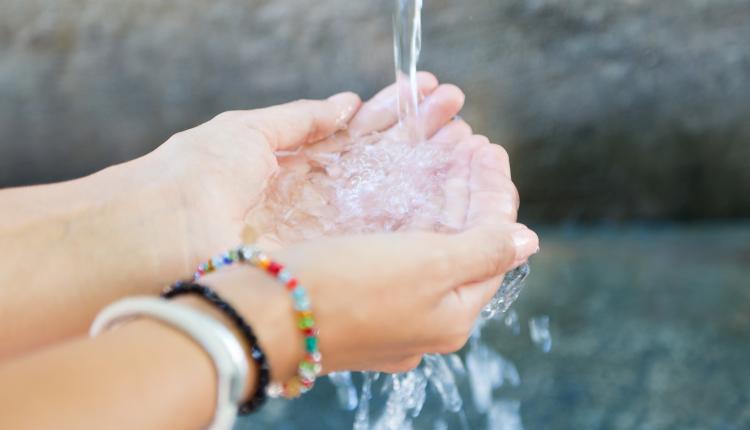 female-collecting-water-in-hands