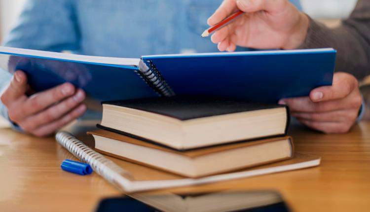 high-angle-of-man-holding-notebook