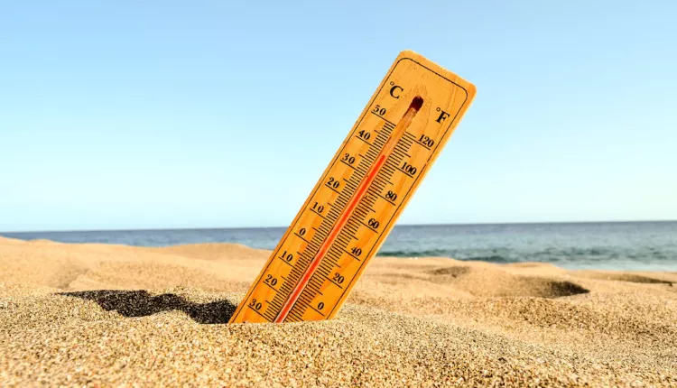 closeup-shot-thermometer-beach-sand_181624-12367