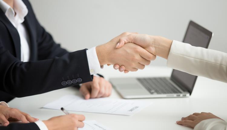 Hr handshaking successful candidate getting hired at new job, cl