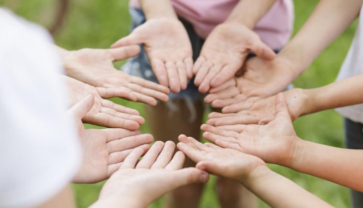 high-angle-friends-making-a-flower-with-their-hands