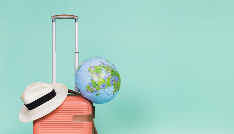 pink-suitcase-with-hat-and-globe-on-it