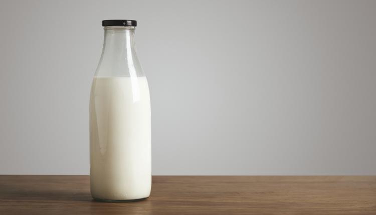 Antic blank bottle with milk on table
