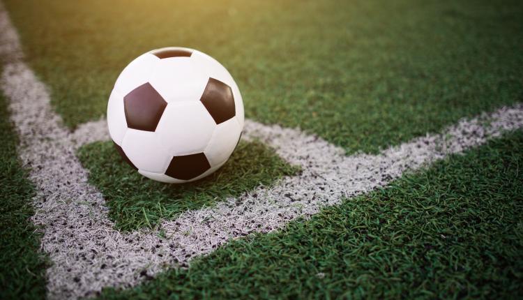 soccer ball on the white line at stadium