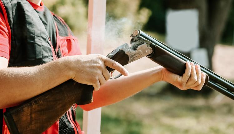 man-opens-the-shotgun-bolt-after-one-shot-with-smoke