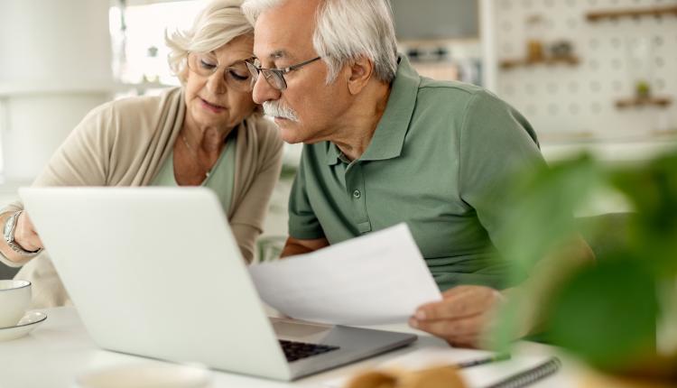 Senior couple analyzing their savings while going through home f