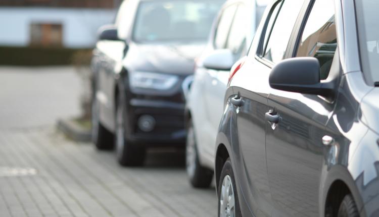 closeup-shot-of-a-black-car-in-the-parking-lot-with-a-blurred-background