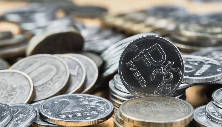 Background blurry out of focus, bokeh, and pasteurization. Coins of the Russian ruble on the table, the change in the exchange rate of the ruble. Idea for economic news banner