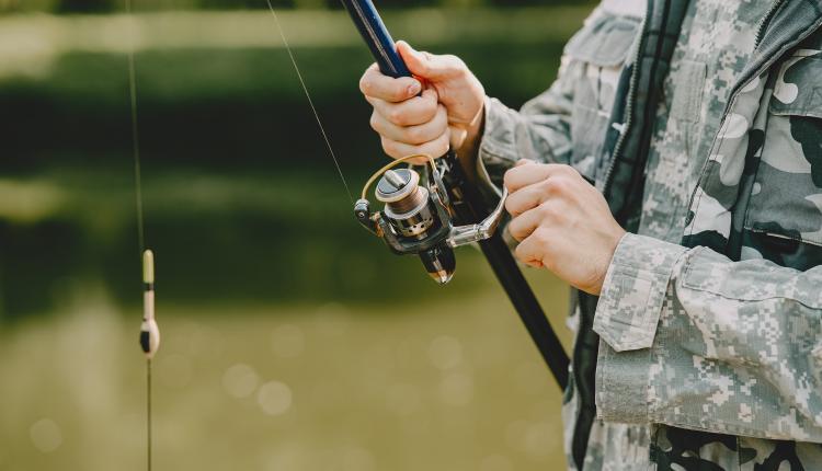 Man fishing and holds the angling rod