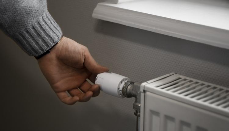 man-turning-off-radiator-during-energy-crisis