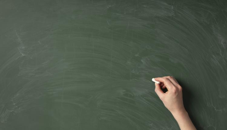 top-view-hand-writing-on-green-board